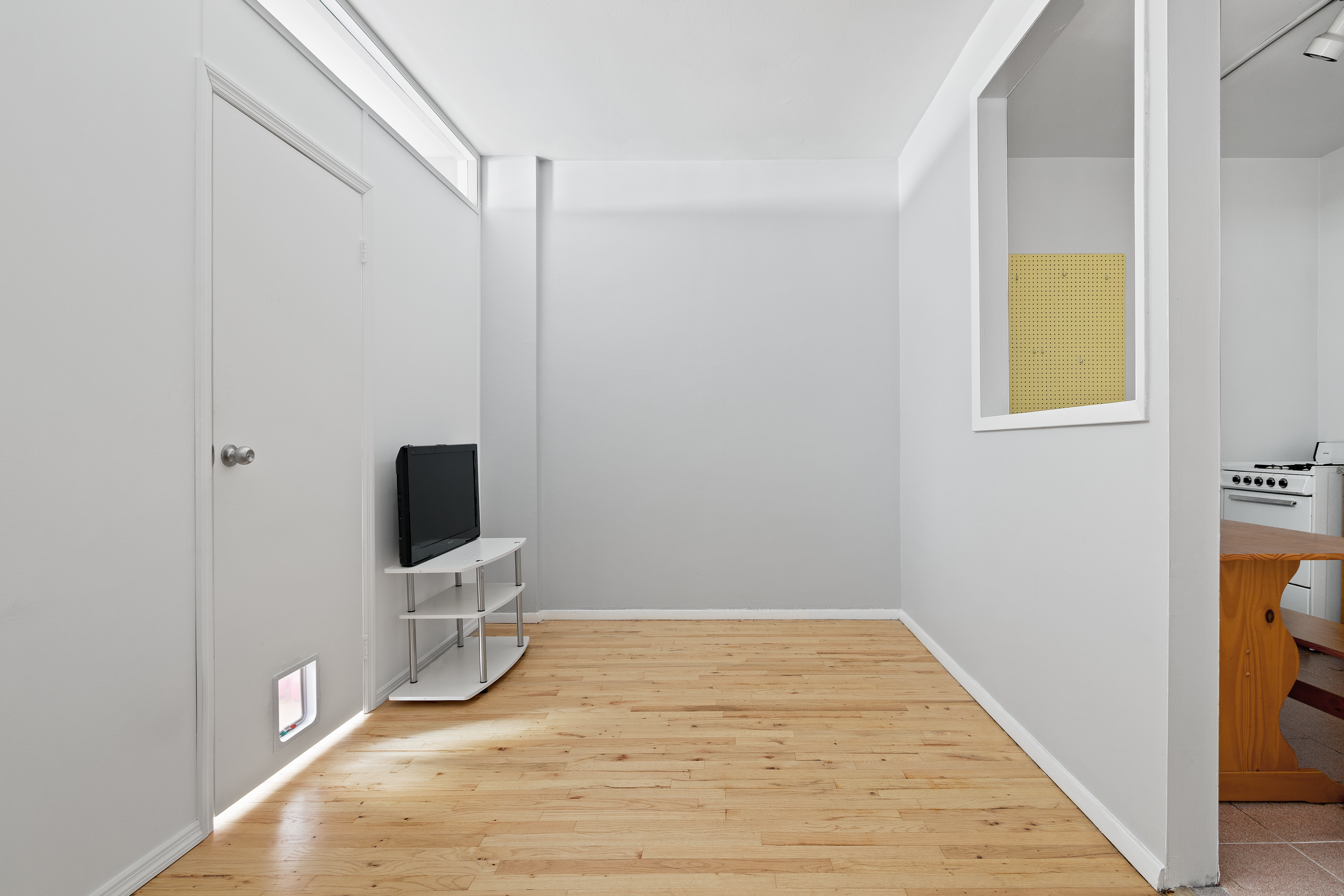 361 3rd Avenue, Unit 1 Manhattan, NY 10016 - Photo 2 of 7 a view of a livingroom with wooden floor and a flat screen tv