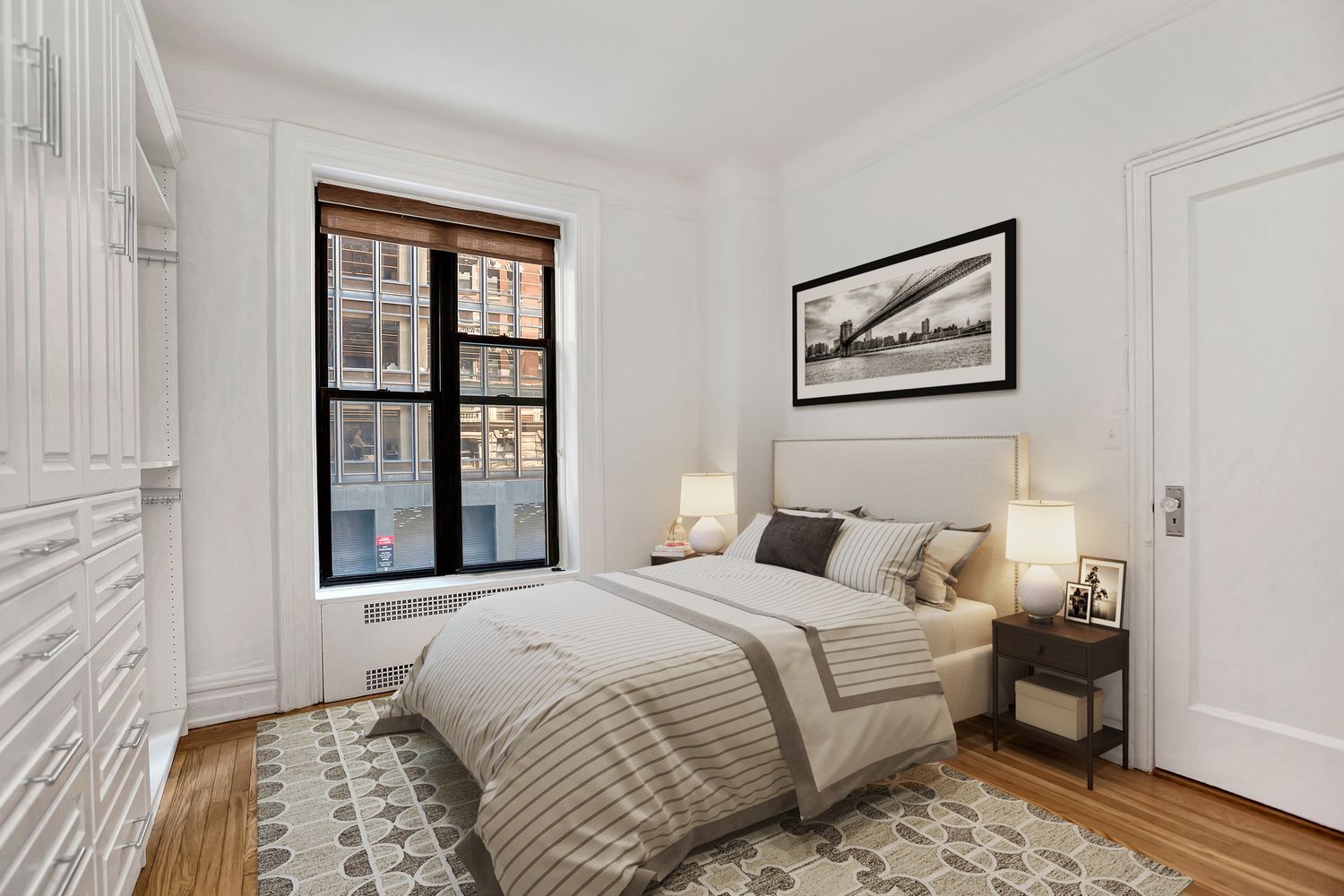 205 West 54th Street, Unit 2E Manhattan, NY 10019 - Photo 5 of 11 a bedroom with bed and a window