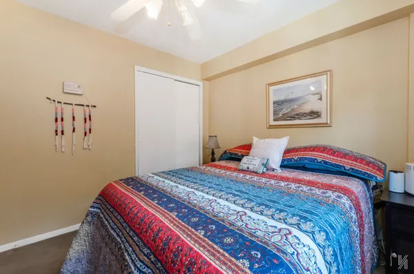 a bedroom with bed and cupboard