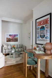 a view of a room with furniture and wooden floor
