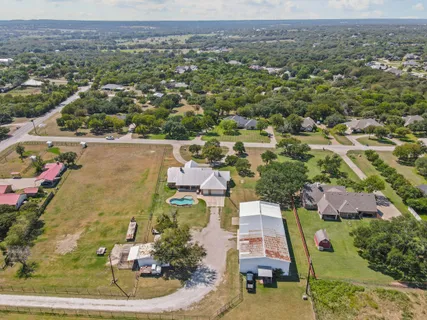 an aerial view of a house with a backyard
