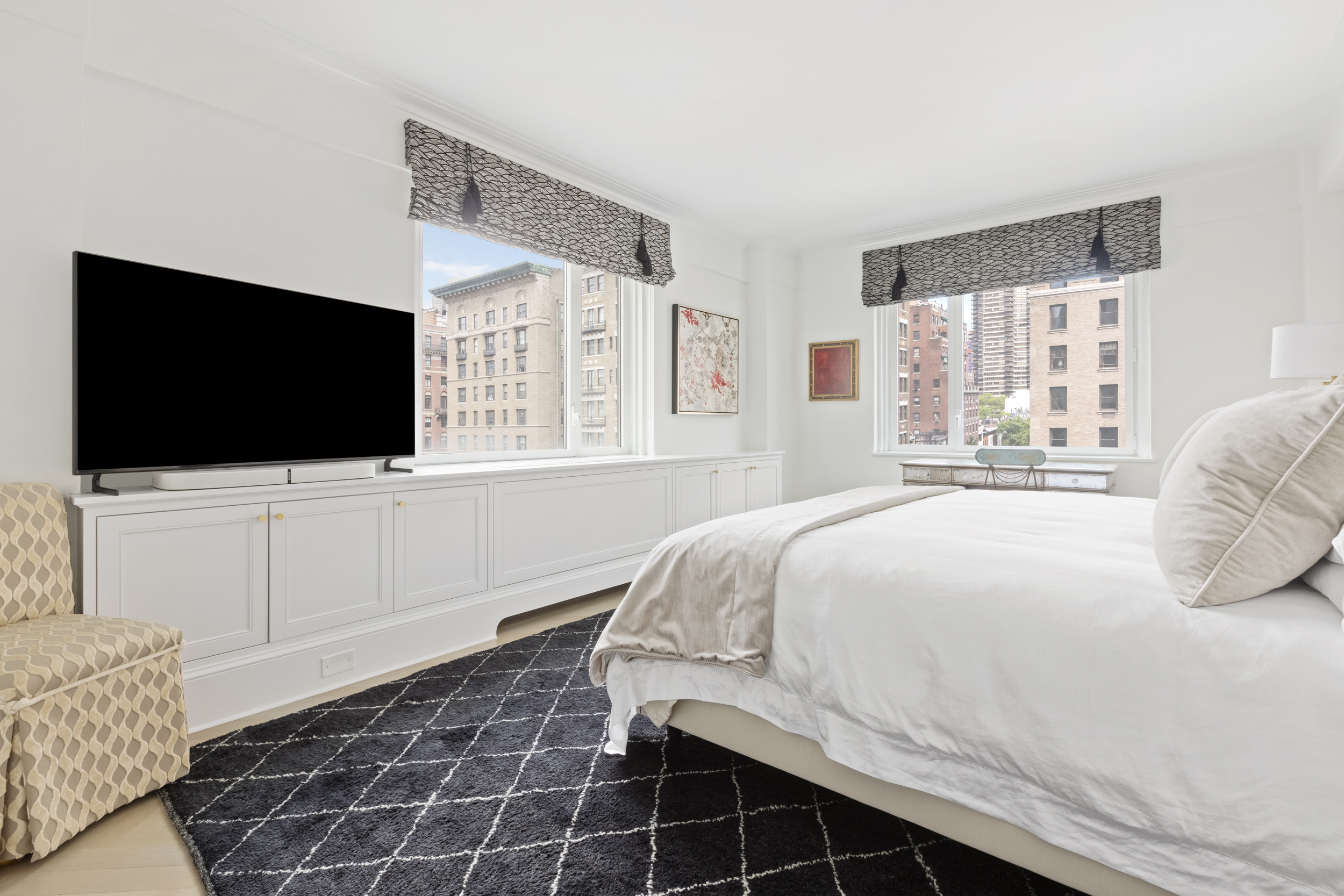 530 Park Avenue, Unit 10D Manhattan, NY 10065 - Photo 7 of 13 a bedroom with a large bed and a flat screen tv