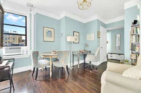 a living room with furniture dining table and wooden floor