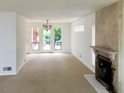 wooden floor in an empty room with a fireplace