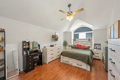 a bedroom with a bed and a chandelier