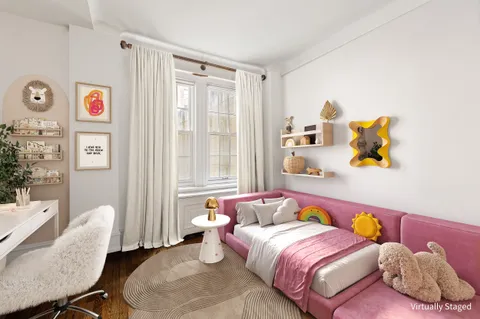 a living room with furniture and two window