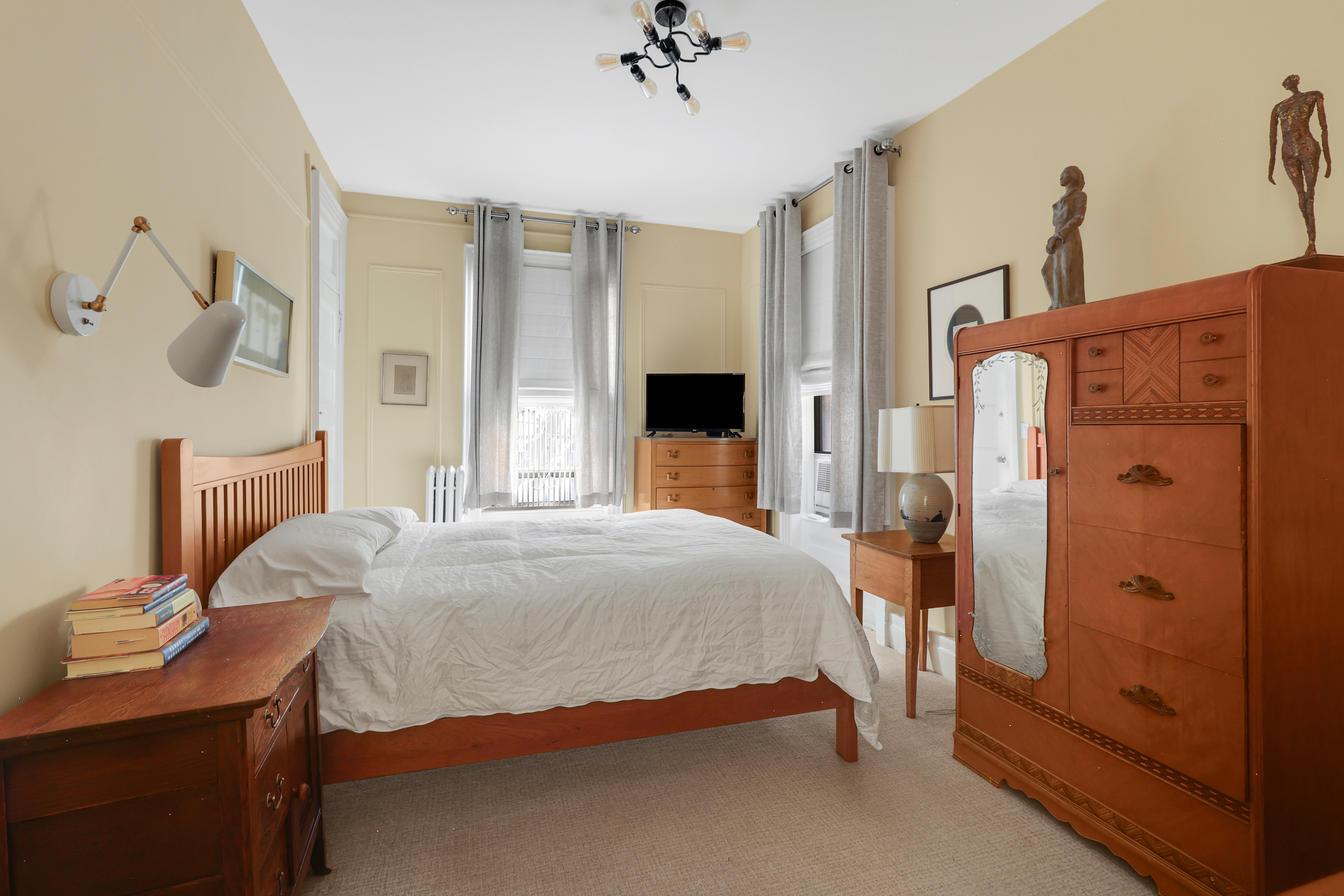 311 West 97th Street, Unit 6E Manhattan, NY 10025 - Photo 11 of 18 a bedroom with a bed and a table