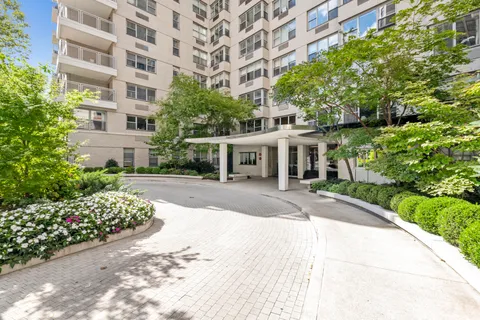 a front view of a building with a garden