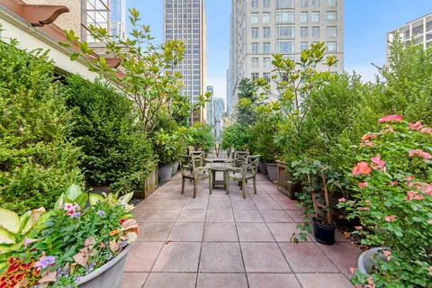 a view of a patio with table and chairs and potted plants
