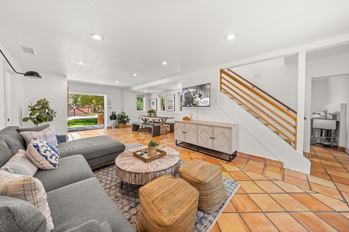 a living room with furniture and wooden floor