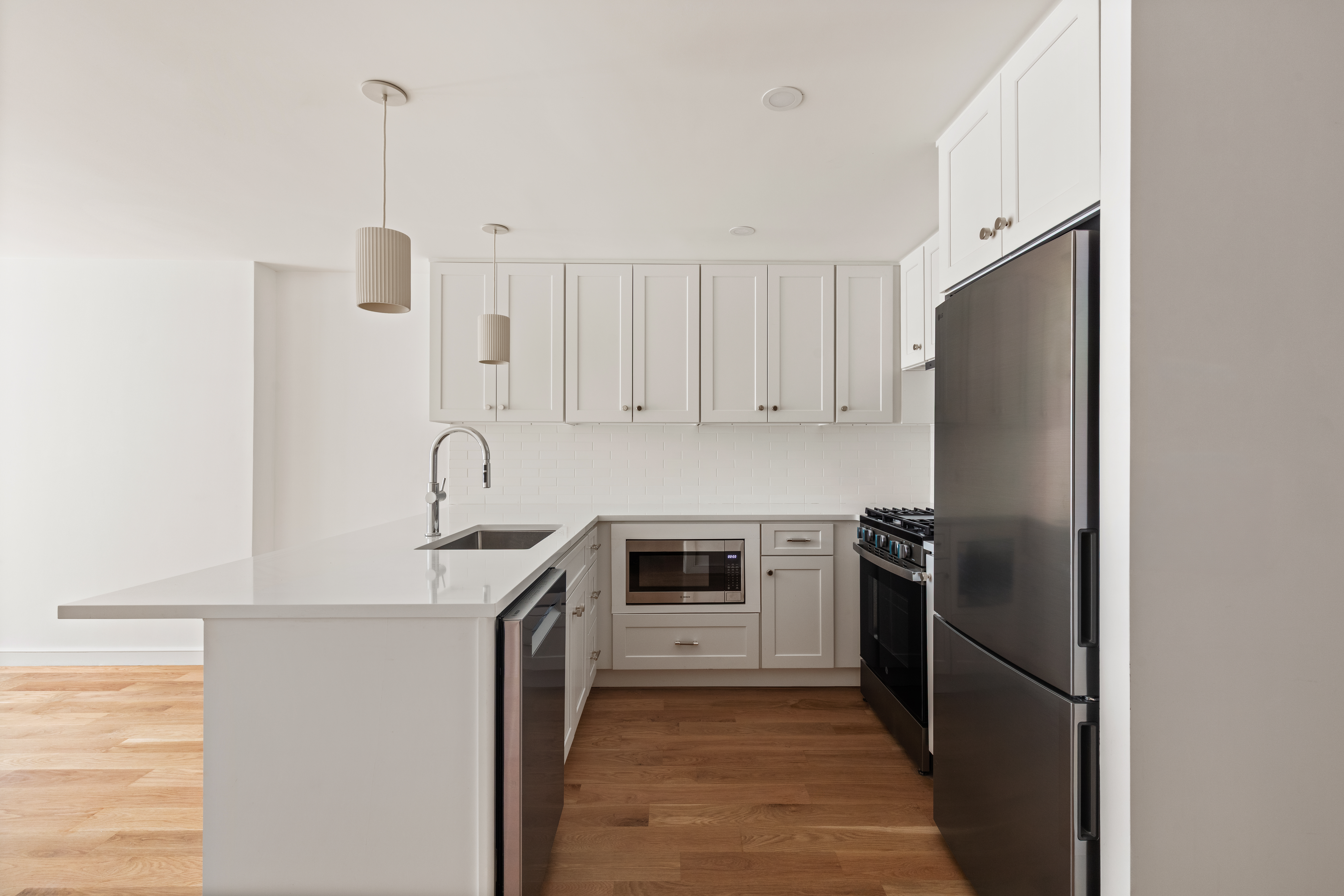 357 Eastern Parkway Brooklyn, NY 11216 - Photo 13 of 15 a kitchen with stainless steel appliances granite countertop a refrigerator a sink and white cabinets