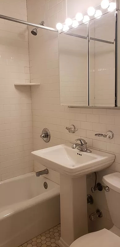 1736 2nd Avenue, Unit DB Manhattan, NY 10128 - Photo 7 of 7 a bathroom with a sink a toilet and shower
