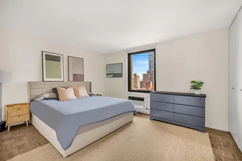 a bedroom with a bed and window