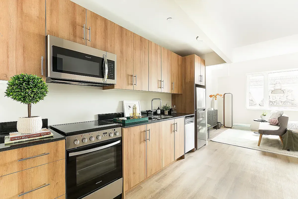 8 Palmetto Street, Unit 305 Brooklyn, NY 11221 - Photo 2 of 10 a kitchen with stainless steel appliances granite countertop a stove a sink and a microwave