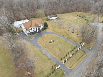 a front view of house with yard and swimming pool