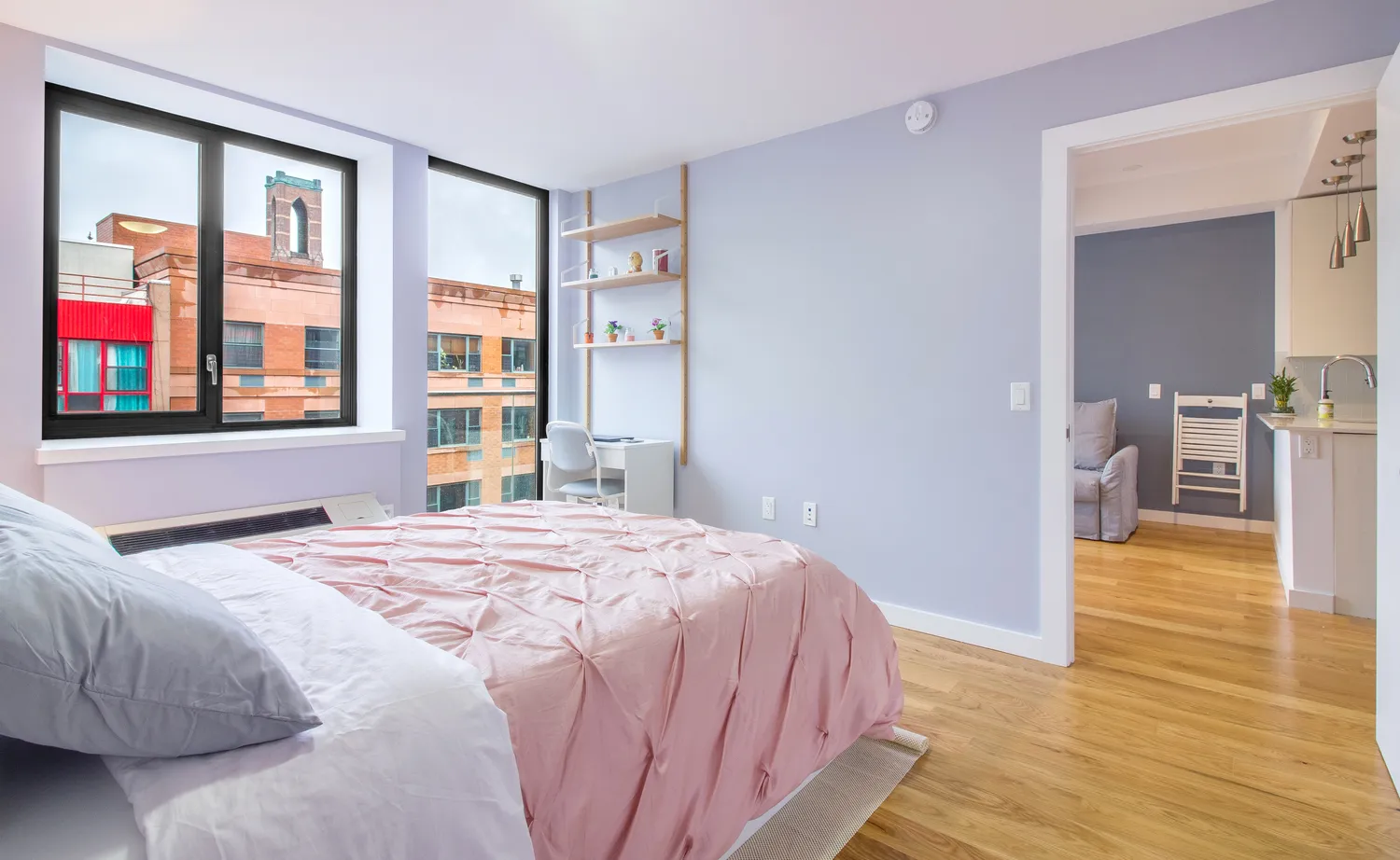 a bedroom with a bed and wooden floor