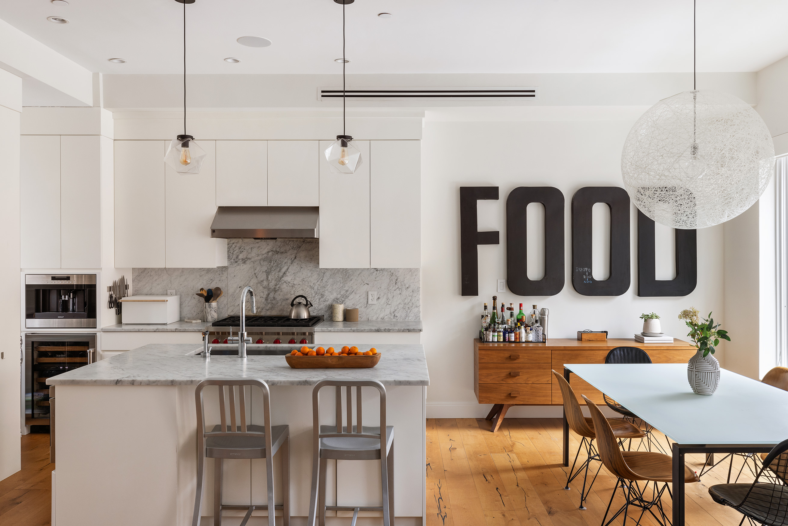 43 Dean Street Brooklyn, NY 11201 - Photo 4 of 17 a kitchen with stainless steel appliances kitchen island granite countertop a table chairs in it and wooden floors