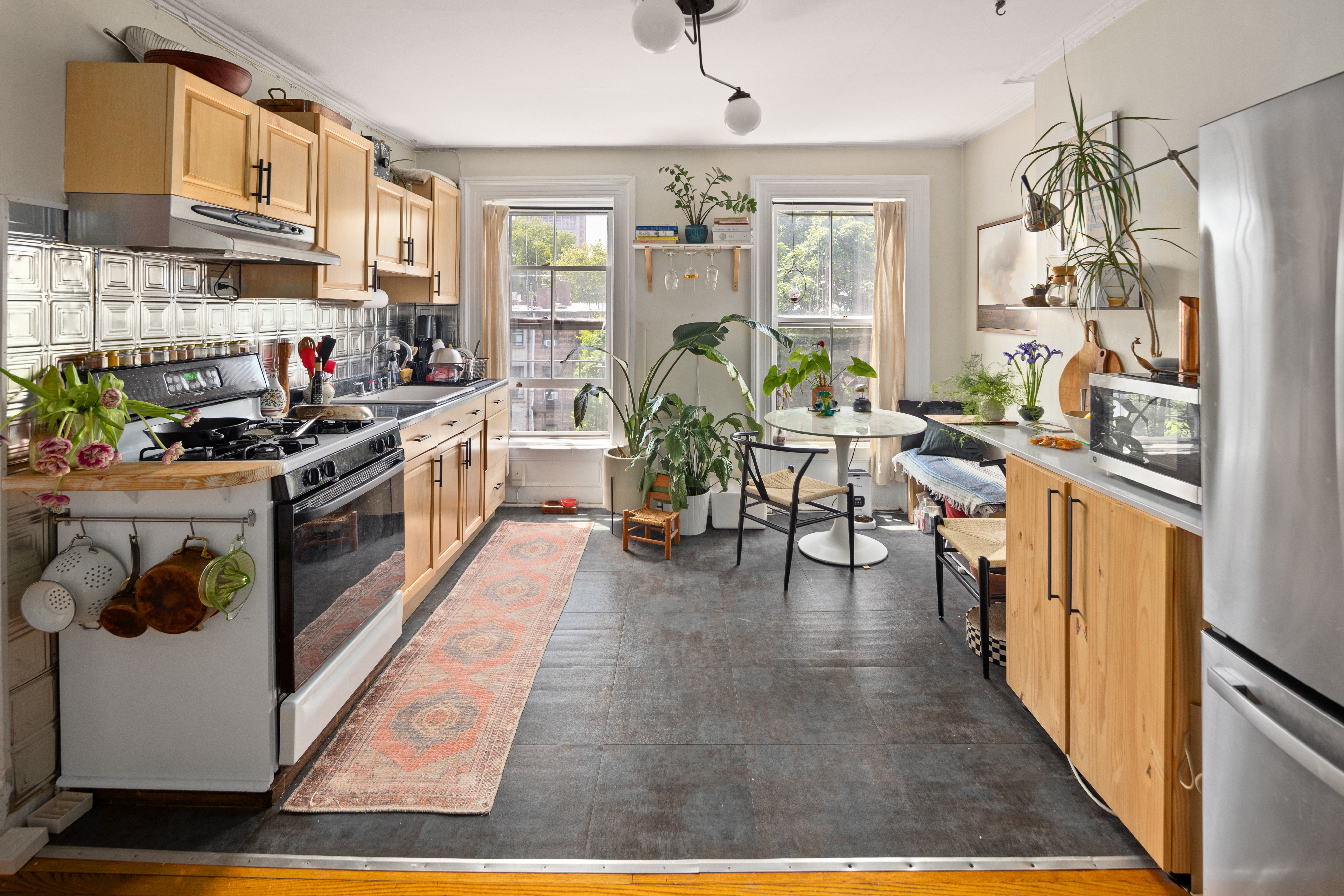 212 Adelphi Street Brooklyn, NY 11205 - Photo 5 of 11 a kitchen with stainless steel appliances granite countertop a stove top oven a sink dishwasher and cabinets with wooden floor