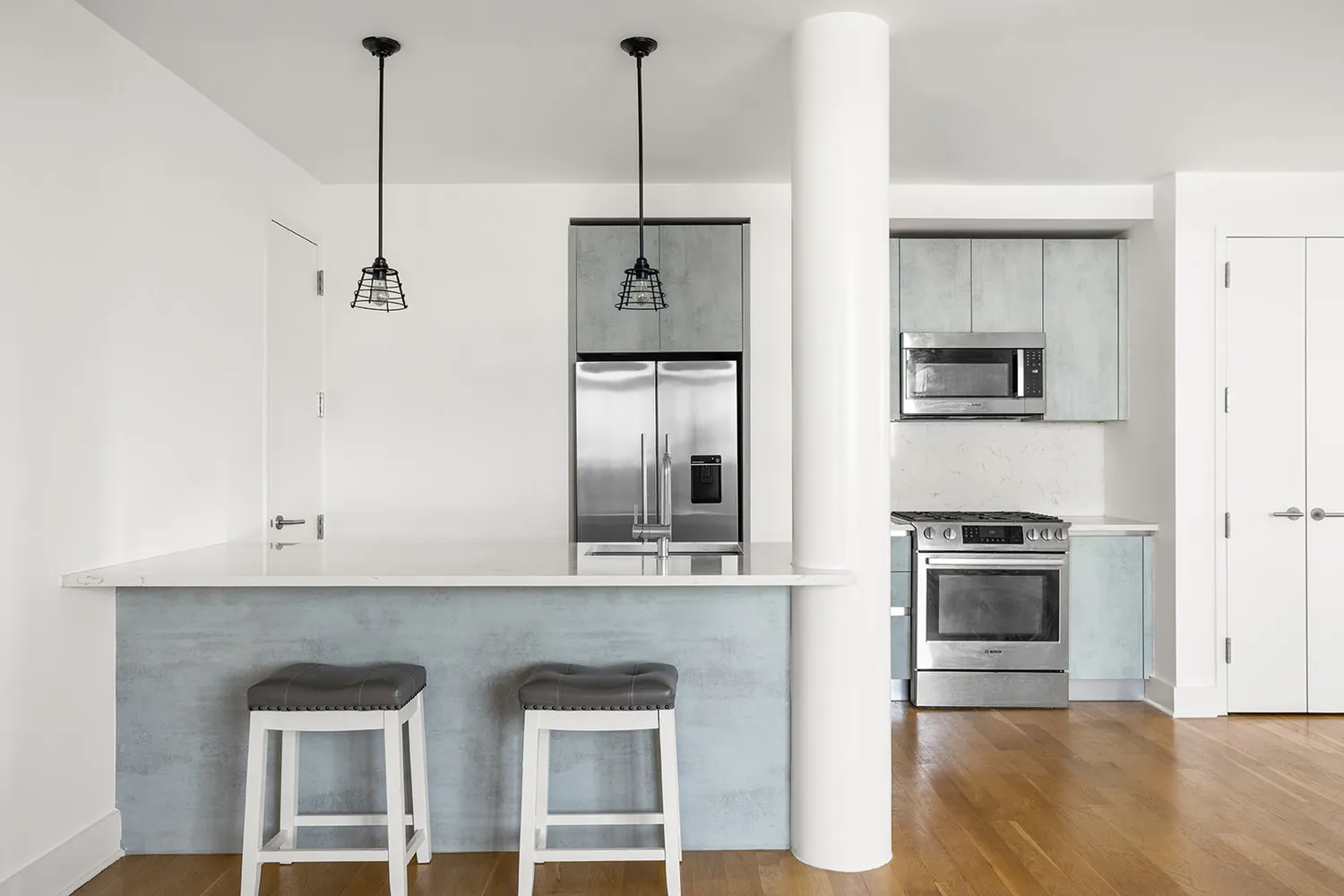 a kitchen with a refrigerator and a stove
