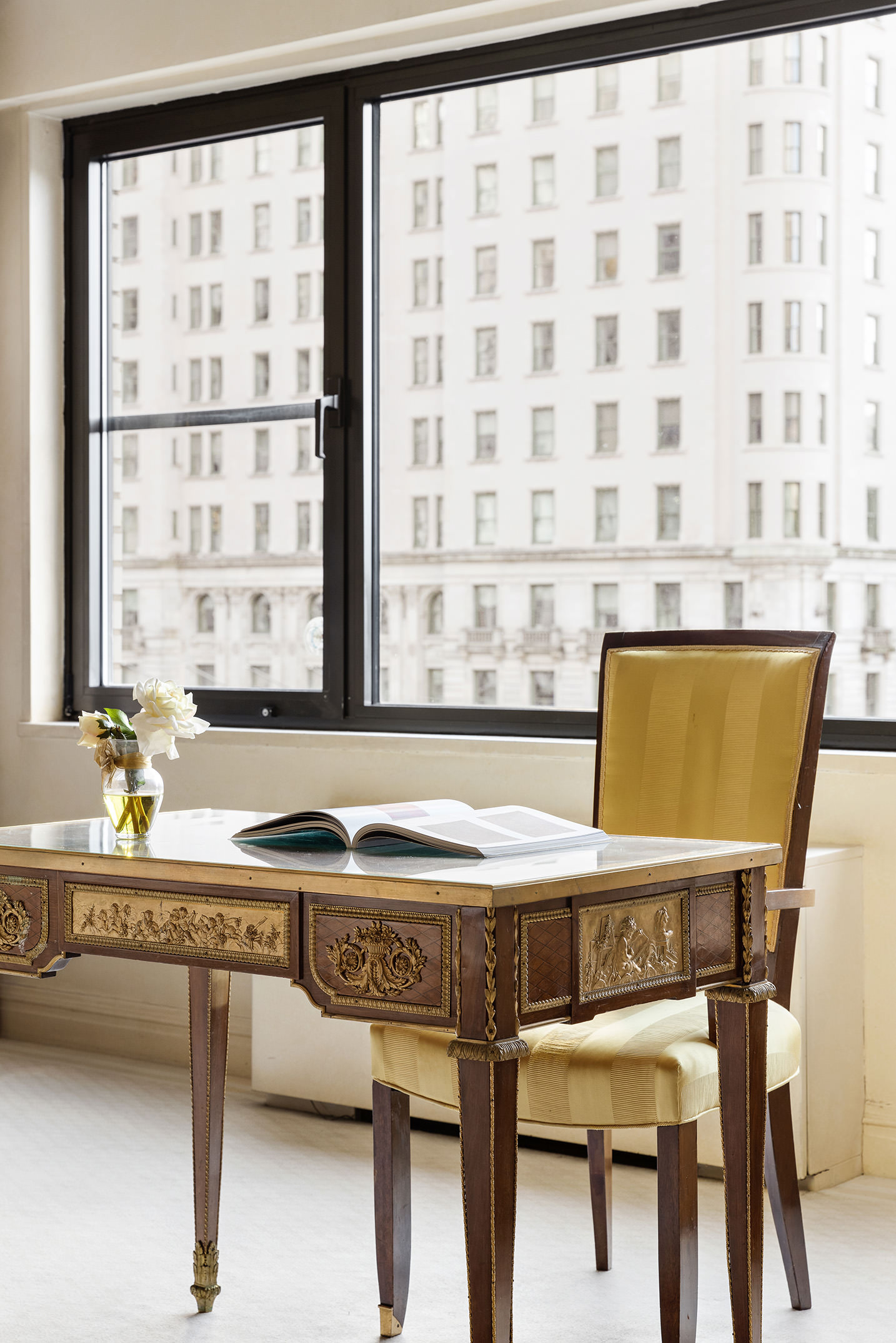 785 5th Avenue, Unit 5C Manhattan, NY 10022 - Photo 6 of 14 a dining table sitting next to a window