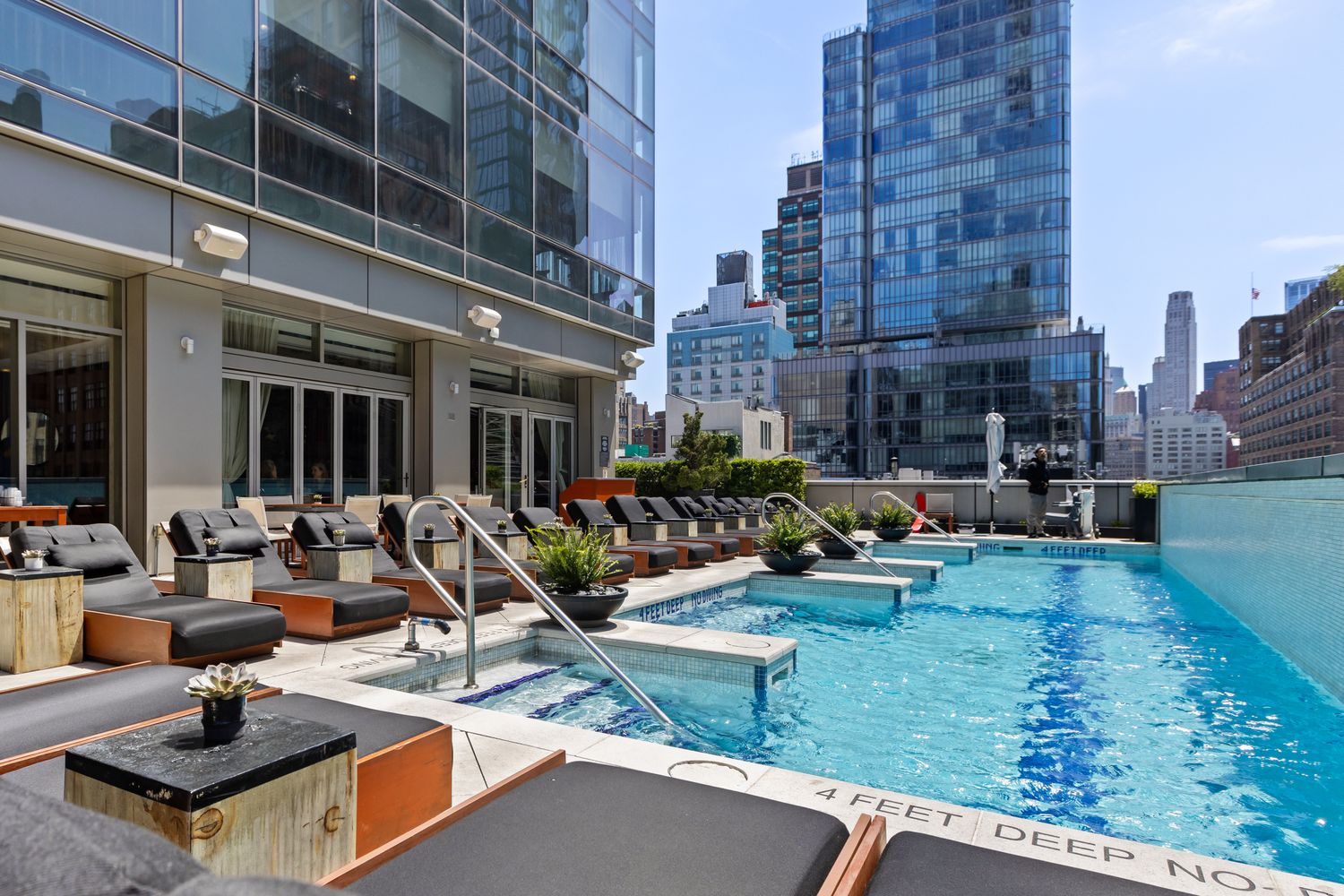 246 Spring Street, Unit 2910 Manhattan, NY 10013 - Photo 15 of 17 a view of a patio with couches table and chairs and potted plants