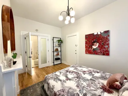 a bedroom with a bed and a chandelier