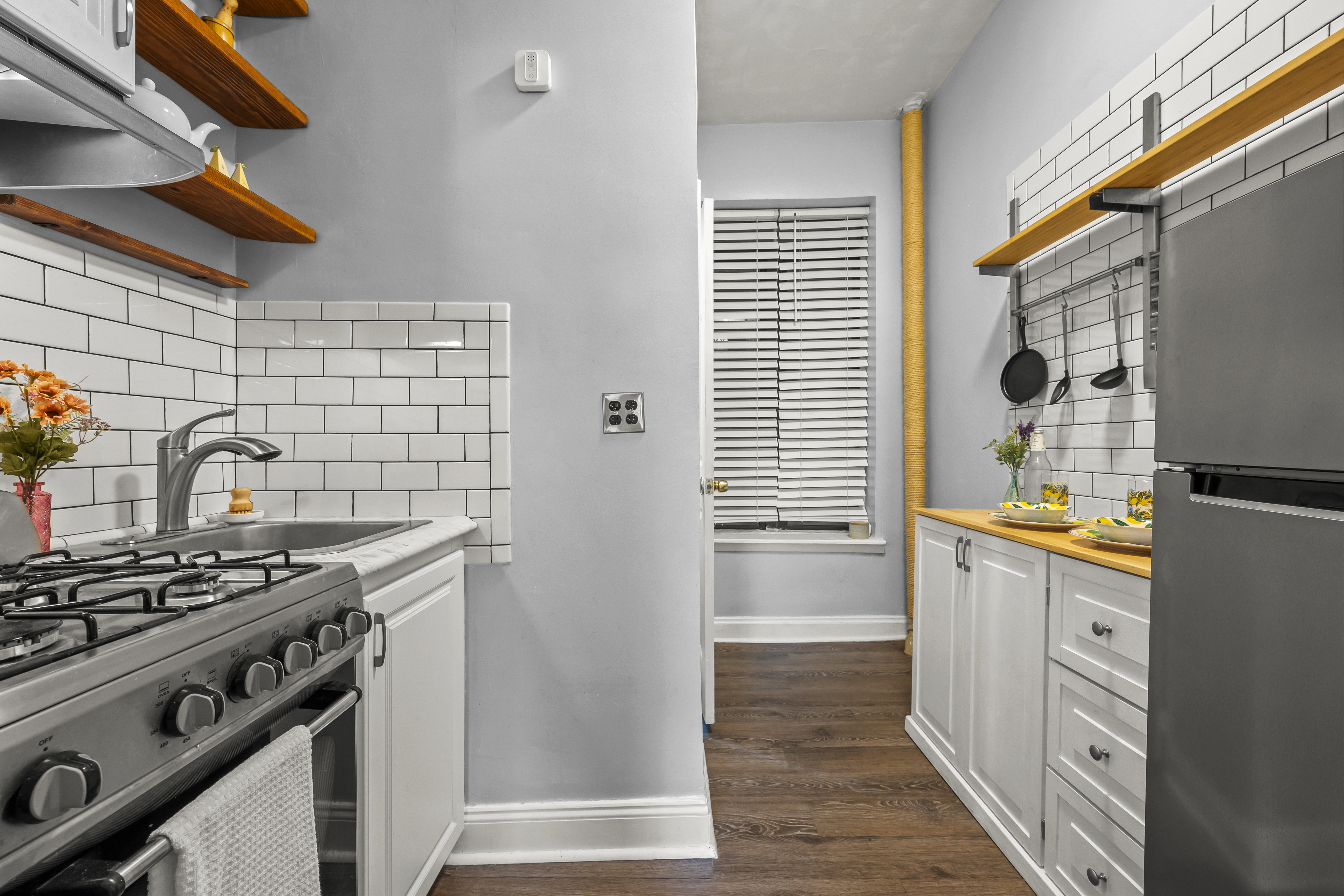 1777 Madison Avenue, Unit 24 Manhattan, NY 10035 - Photo 4 of 20 a kitchen with stainless steel appliances a stove a sink and a refrigerator