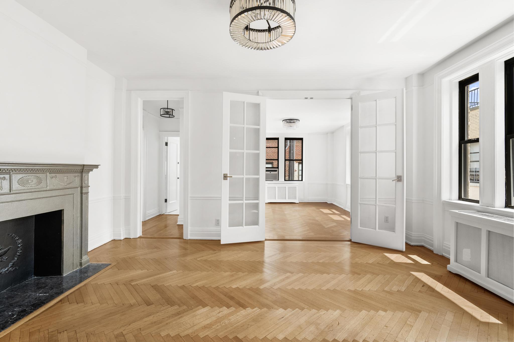 885 West End Avenue, Unit 12D Manhattan, NY 10025 - Photo 4 of 24 a view of livingroom with hardwood floor and a fireplace
