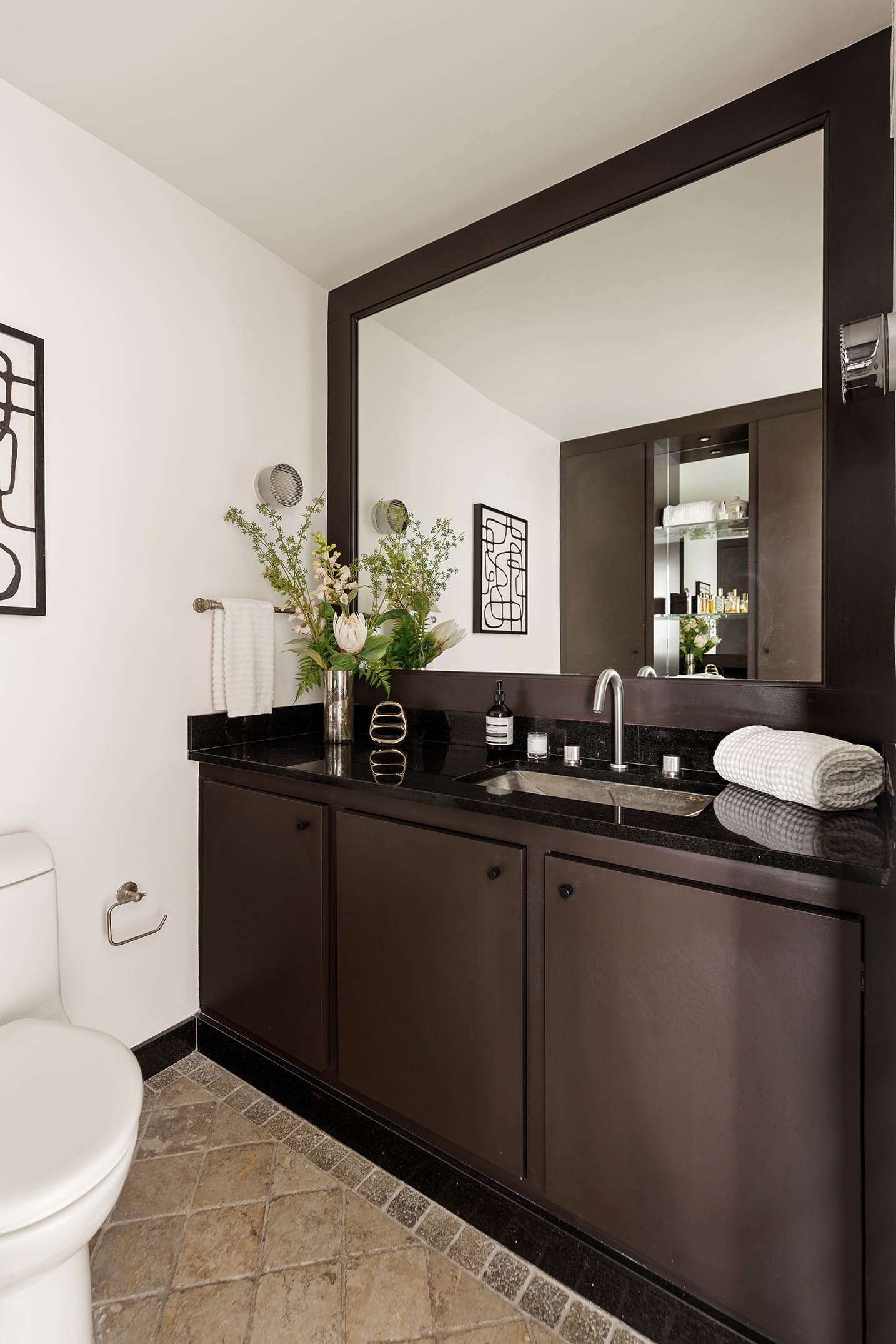 295 Greenwich Street, Unit 8/9H Manhattan, NY 10007 - Photo 17 of 22 a bathroom with a sink a toilet and mirror