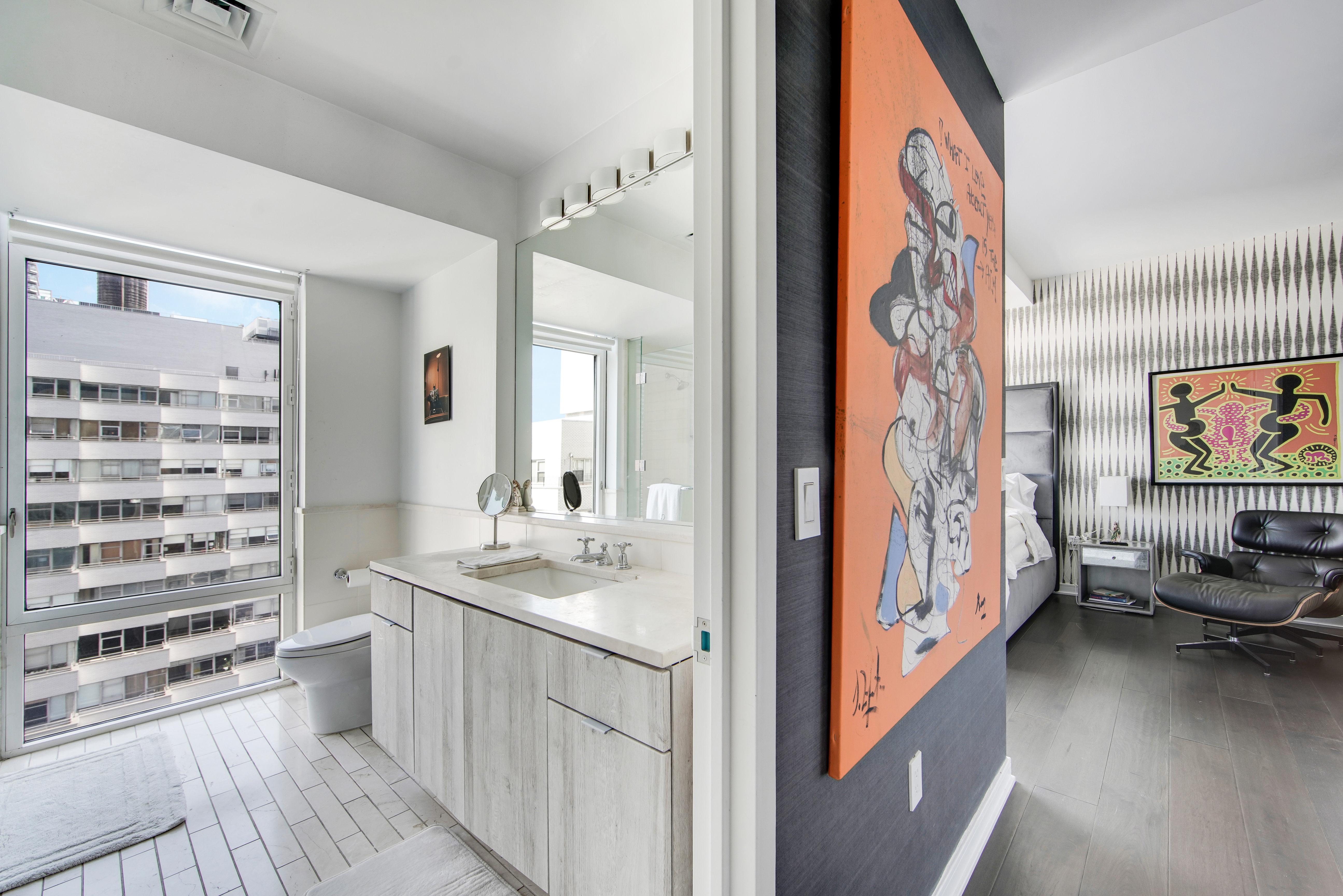 207 East 57th Street, Unit 20A Manhattan, NY 10022 - Photo 7 of 18 a hallway with a bed and a couch