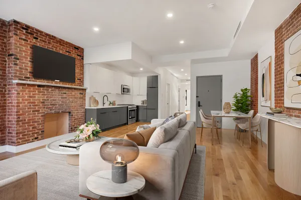 a living room with fireplace furniture and a flat screen tv