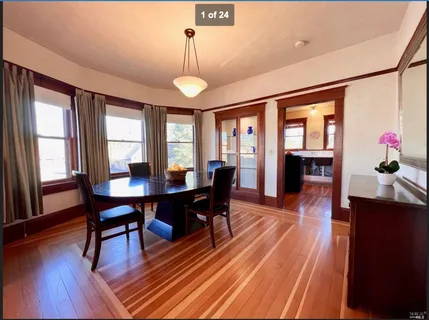 a view of a dining room with furniture window and wooden floor