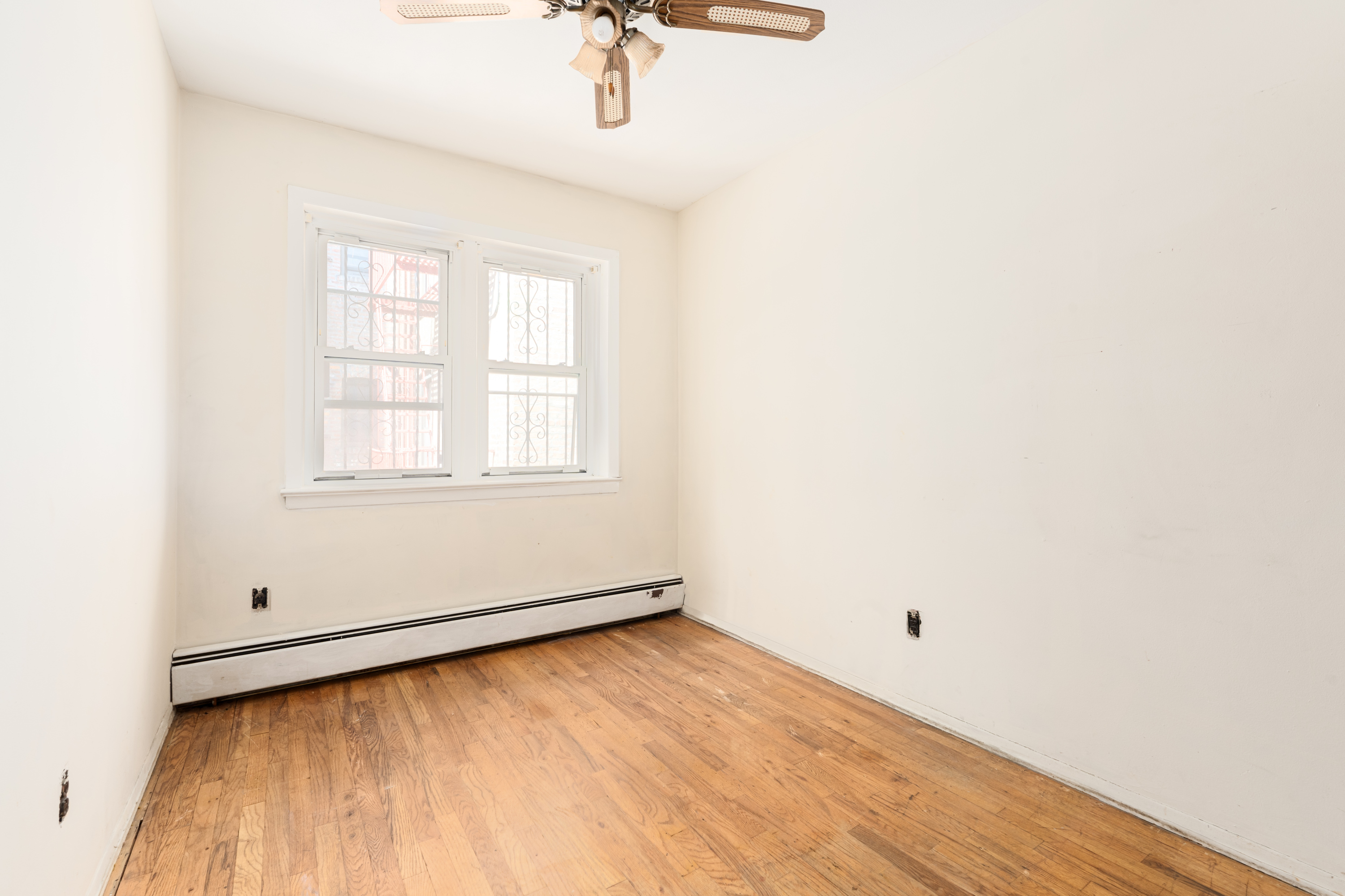 143-17 101st Avenue Queens, NY 11435 - Photo 4 of 10 an empty room with a window
