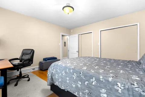 a bedroom with a bed and a desk
