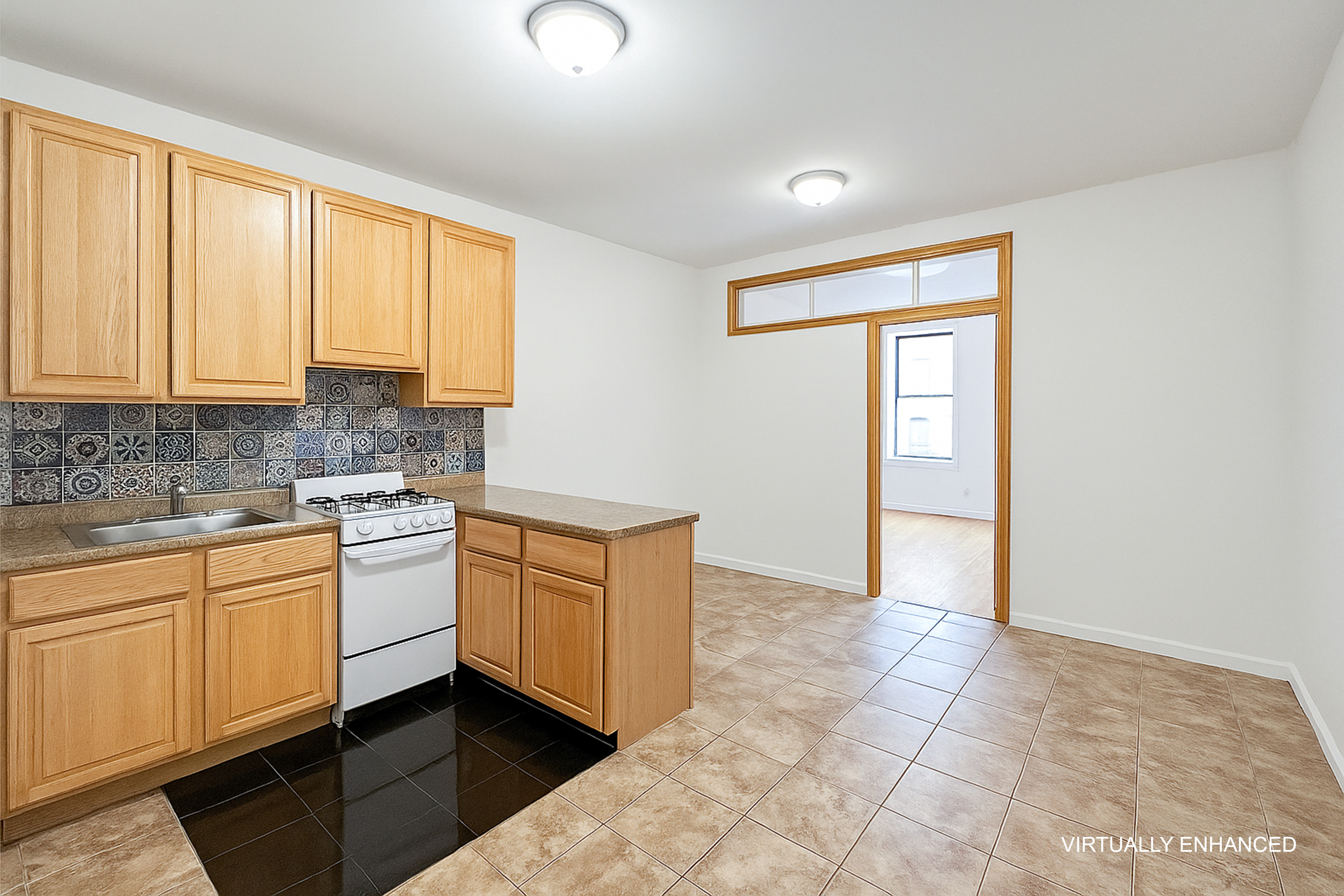 a kitchen with stainless steel appliances granite countertop a stove a sink and white cabinets
