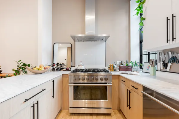 a kitchen with a stove and white cabinets