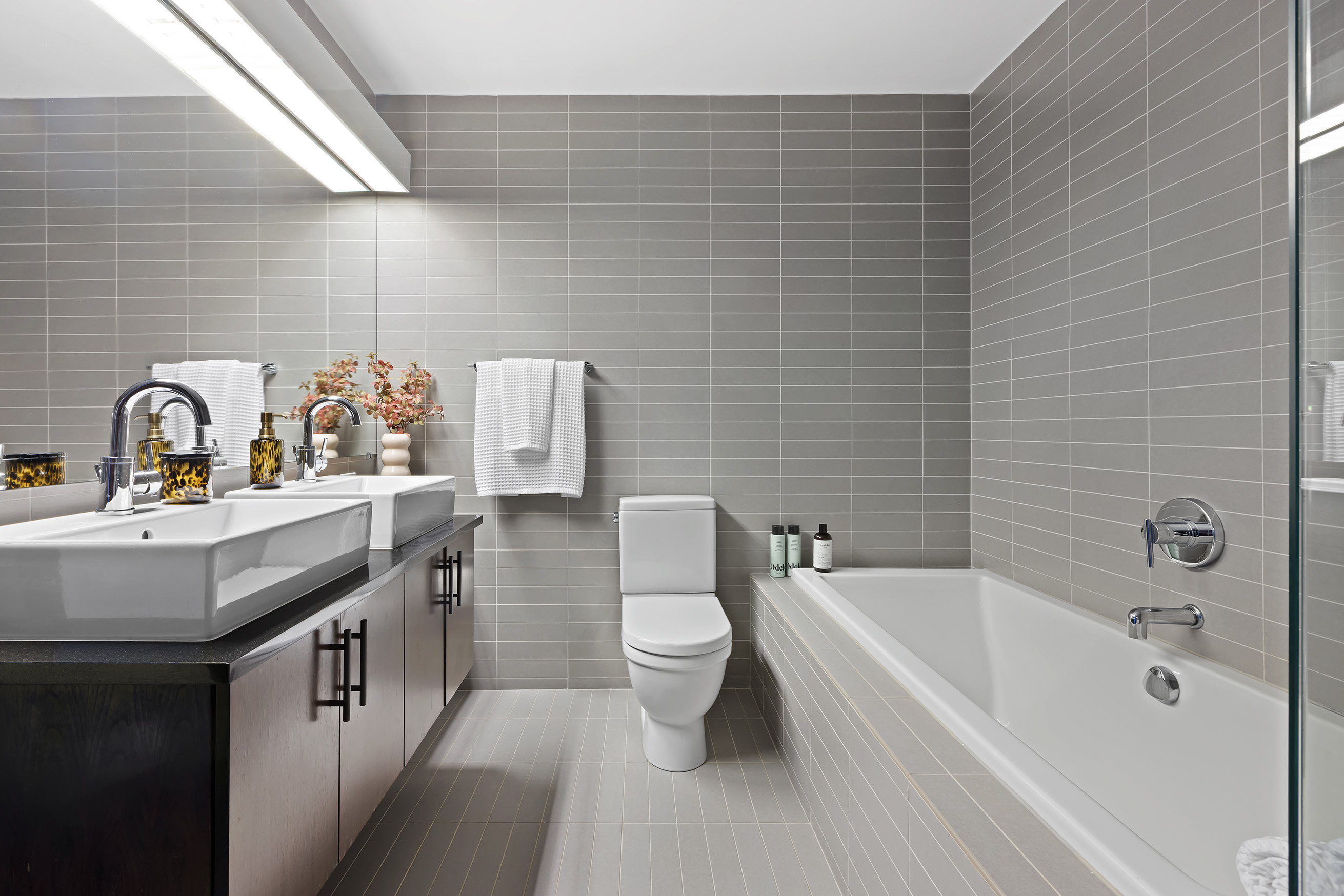 150 Myrtle Avenue, Unit 2506 Brooklyn, NY 11201 - Photo 13 of 16 a bathroom with a granite countertop sink a toilet and bathtub