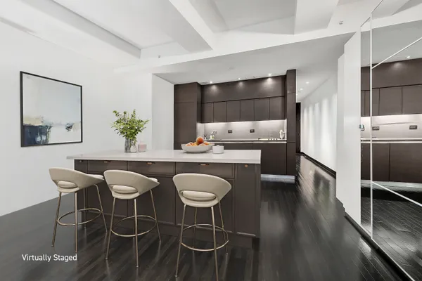 a kitchen with stainless steel appliances kitchen island granite countertop a dining table chairs and white cabinets