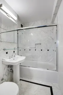 a bathroom with a sink mirror and toilet