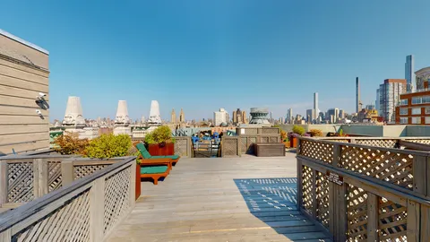 a balcony with hardwood filled with table and chairs