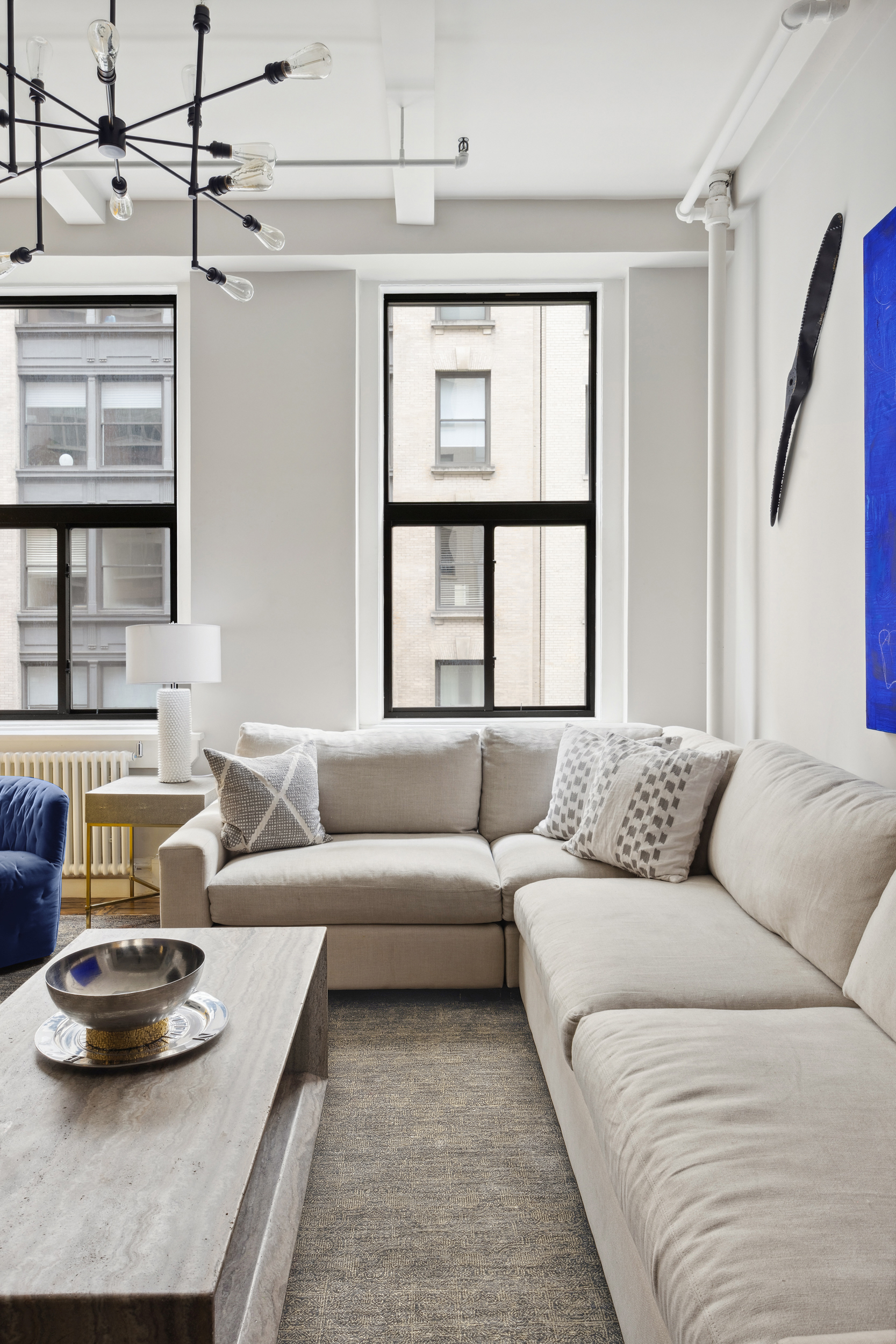 129 West 22nd Street, Unit 5A Manhattan, NY 10011 - Photo 3 of 13 a living room with furniture and a window