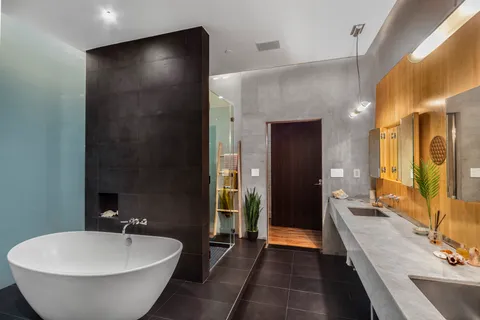 a bathroom with a double vanity sink and a bathtub