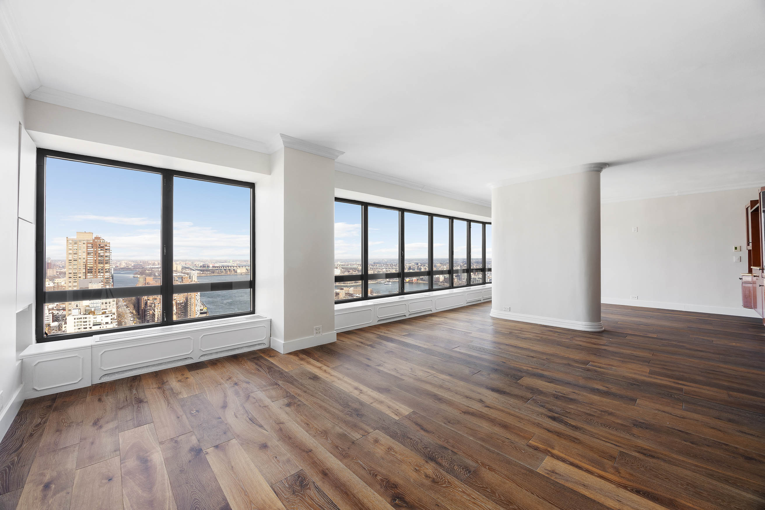 530 East 76th Street, Unit PH36/37E Manhattan, NY 10021 - Photo 2 of 29 wooden floor in an empty room with a window