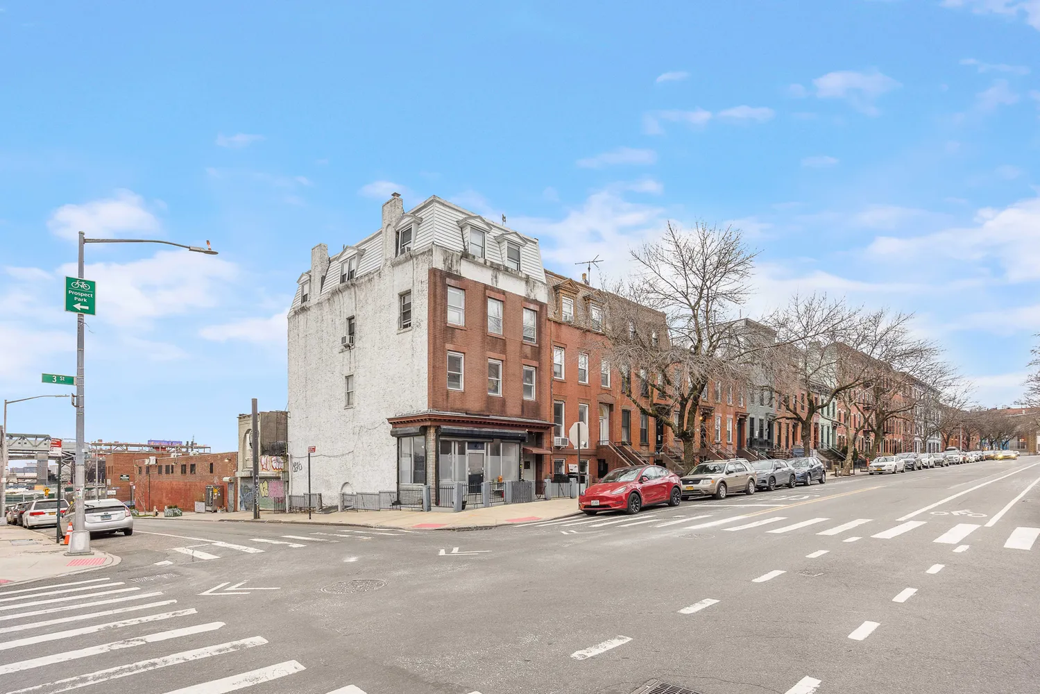 a city street with tall buildings in the background