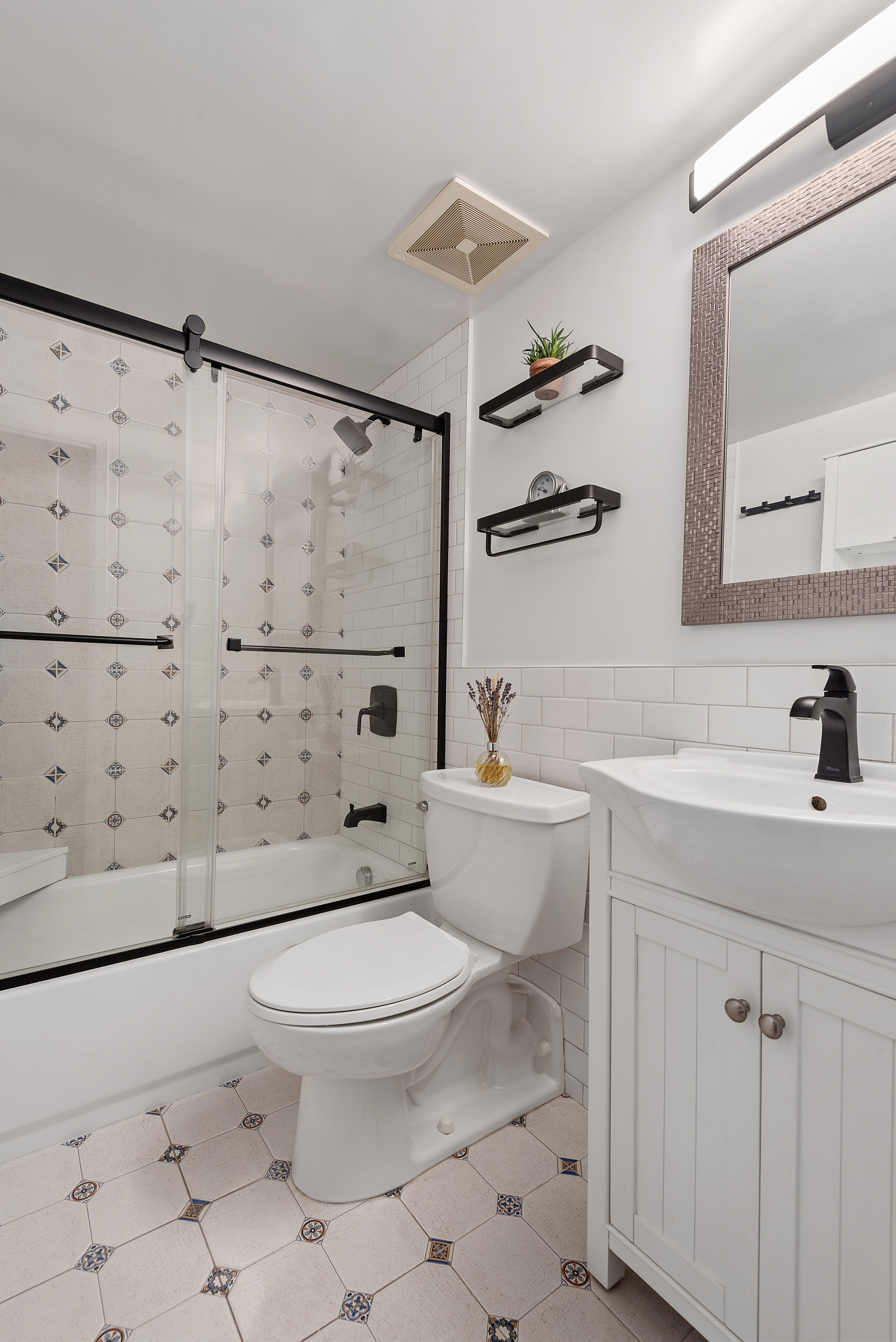 9951 Shore Road, Unit 1B Brooklyn, NY 11209 - Photo 7 of 9 a bathroom with a toilet a sink and a shower