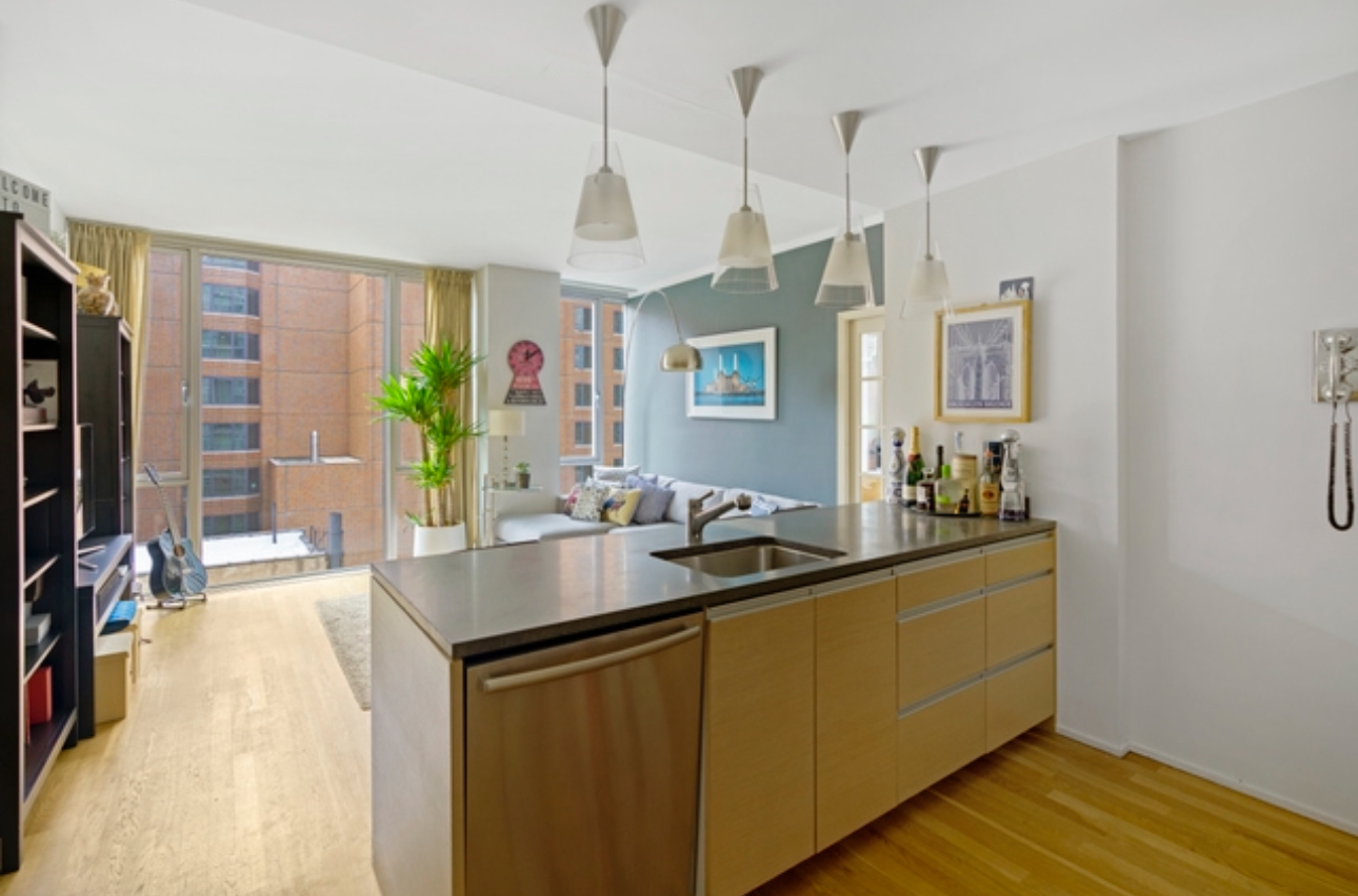 110 3rd Avenue, Unit 9B Manhattan, NY 10003 - Photo 4 of 14 a kitchen with a sink stove and a refrigerator