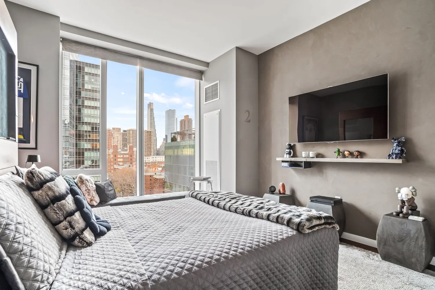 a bedroom with a bed and a flat screen tv