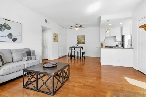 a living room with furniture and a wooden floor