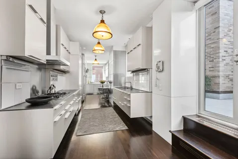 a kitchen with stainless steel appliances a stove a sink and a refrigerator