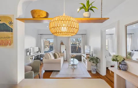a living room with furniture and a chandelier
